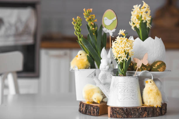 istock Happy Easter. Spring yellow hyacinth flowers in an egg-shaped vase, chicken chicks on a white table. In the background is a white Scandinavian-style kitchen. Easter decor in the house. 2091375966