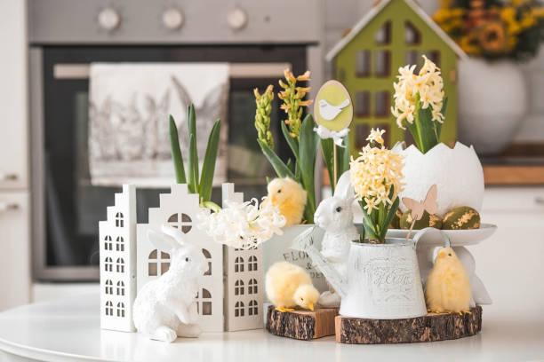 istock Happy Easter. Spring yellow hyacinth flowers in an egg-shaped vase, chicken chicks on a white table. In the background is a white Scandinavian-style kitchen. Easter decor in the house. 2091375970