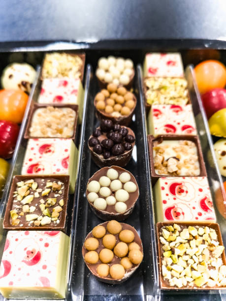 istock Small box of colorful and tiny chocolates with different stuffings and christmas decorations 2091396051