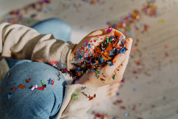 istock Boy collecting bright confetti from floor 2091405928