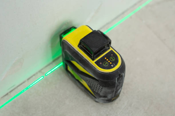 istock Construction laser level and the hands of a worker. Builder measures the level. Repair concept. 2091430358