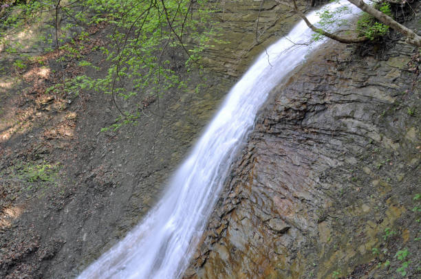 Shades State Park Indiana has sandstone cliffs overlooking Sugar Creek, with many ravines and waterfalls.  This park is adjacent to a better know Turkey Run State Park with similar hollows and waterfalls, but if you want less crowds, Shades is my favorite of the two.  When young my Mom helped \