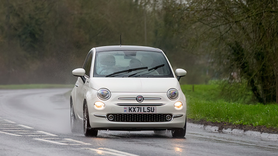 Milton Keynes,UK-Mar 17th 2024:  2021 white Fiat 500 Dolcevita car driving in the rain