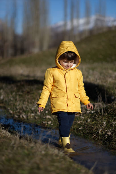 istock Little boy playing with toys in mud 2091454405