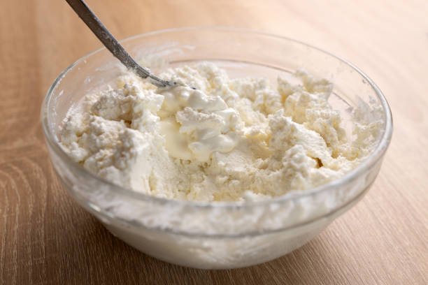 istock Sour cream is added to sour milk cheese and mixed. 2091468111