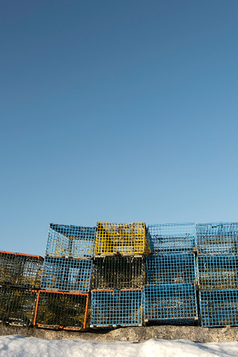 Metal lobster traps against a blue sky.