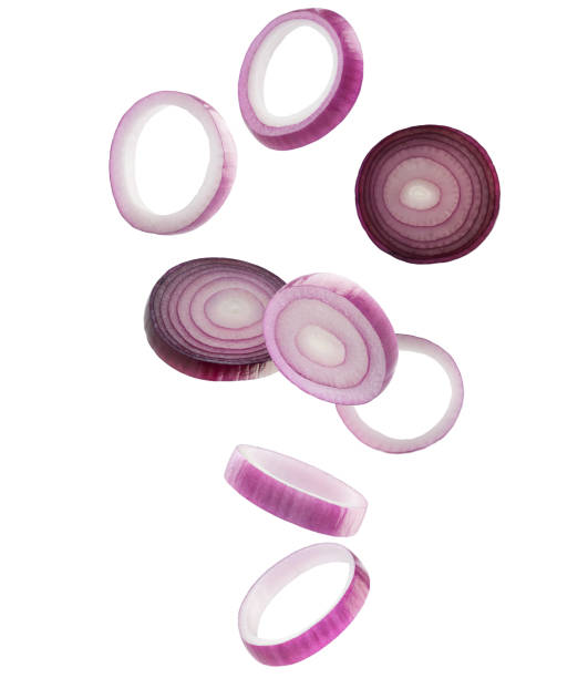 istock Red onion rings and slices fall in space. Volumetric light from behind. Isolated on white 2091560952