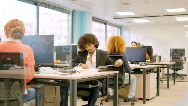 istock Multiethnic coworkers working with computers on desks 2091566751