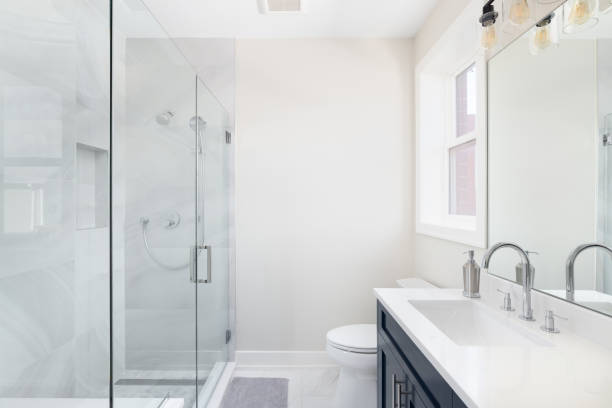 istock A  bathroom with a blue cabinet and white marble walk-in shower. 2091579260