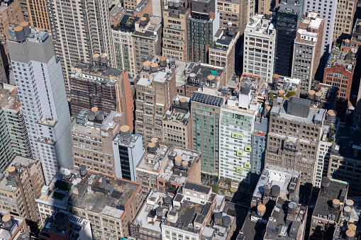 Helicopter view of Manhattan on a sunny day. Overview of the roofs of the skyscrapers in Manhattan.