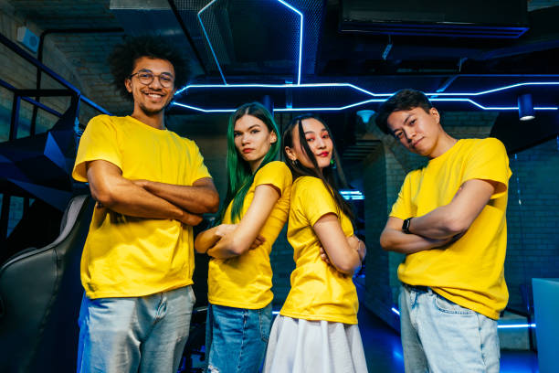 Multiethnic group of young friends playing videogames - Team of professional esport gamers playing in competitive video games on a cyber games tournament