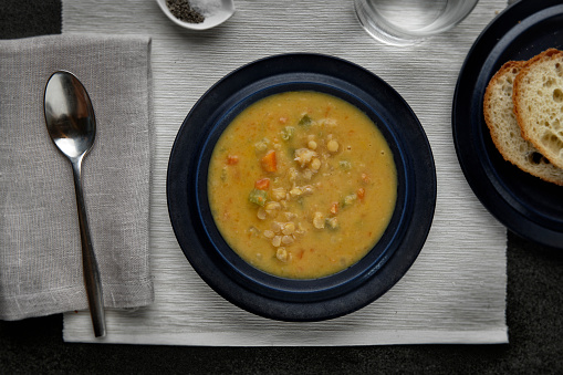 A photograph of a delicious hearty Vegetable Soup shot from above
