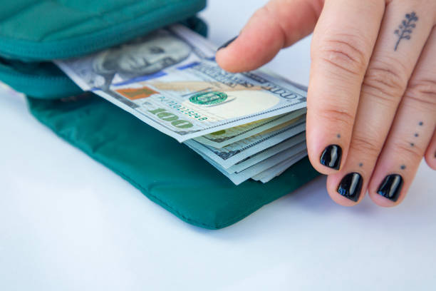 A stack of dollar bills in a wallet on the table