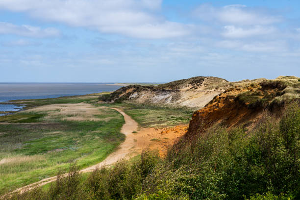 Beach and red sandstone cliffs on a summer day (Island of Pointe-Aux-Loups, Iles de la madeleine archipelago)