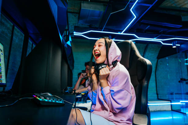 istock Beautiful young asian woman playing videogames at computer 2091641564