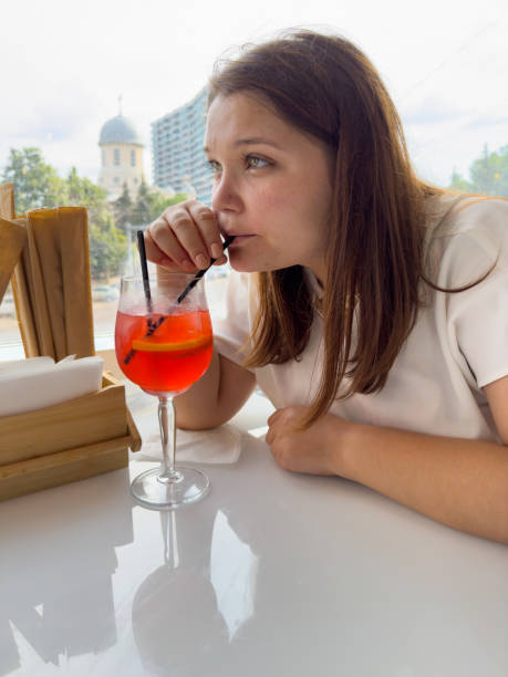istock Cute woman drinking red cocktail 2091644201