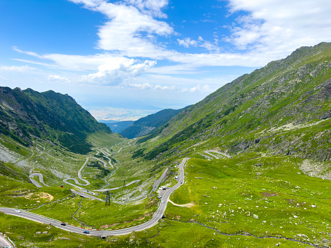 Amazing view of the winding road between the green mountains
