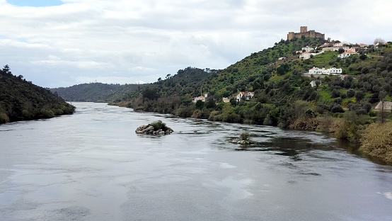 Tagus River, with the hilltop medieval Castle of Belver, on the right bank, overlooking the landscape, Belver, Portugal