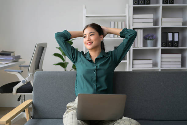 istock A woman is sitting on a couch with her head on her hand 2091696159