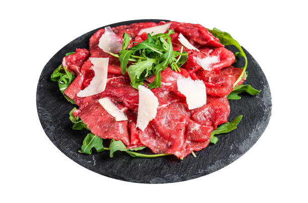 Beef carpaccio with arugula, parmesan cheese.  Isolated on white background. Top view