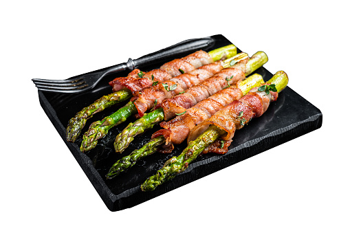 Asparagus Baked with bacon and spices.  Isolated on white background. Top view