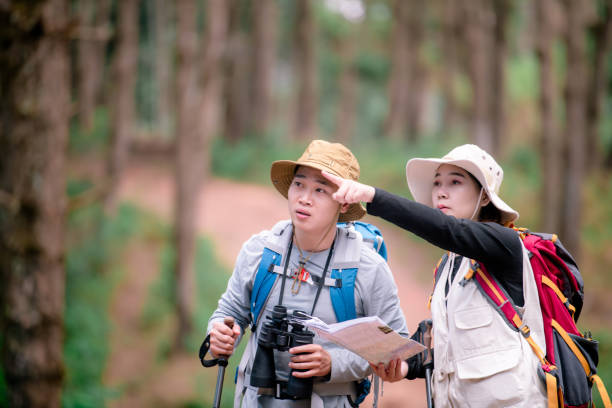 istock Attractive young couple hiking in the forest using binoculars. 2091713997