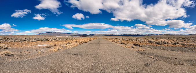 Desolate desert scene with an empty asphalt road