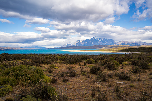 Torres del Paine national park mountain range from a distance on a cloudy day during summer in Patagonia, Chile