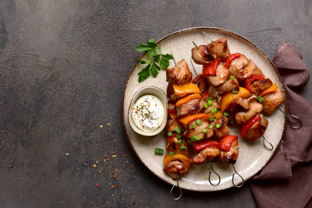 istock Grilled chicken skewer kebab with greek yogurt. Top view with copy space. 2091728991
