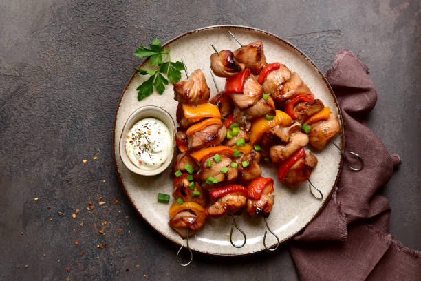 istock Grilled chicken skewer kebab with greek yogurt. Top view with copy space. 2091730548