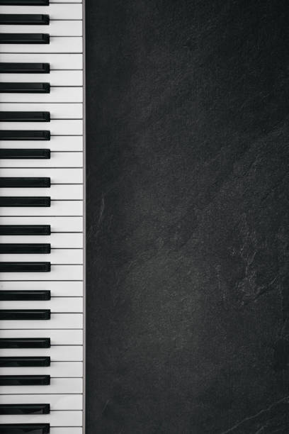 istock Musical keyboard on a textured black background, flat lay, copy space. 2091733693