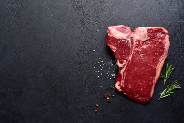 istock Raw organic T-bone steak with spices. Top view with copy space. 2091733722