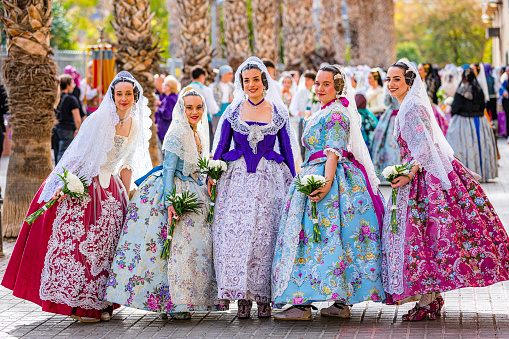 March 17, 2024 Valencia-Spain. Group of girls posing for pictures wearing traditional costume during Las Fallas festivities in Valencia-Spain
