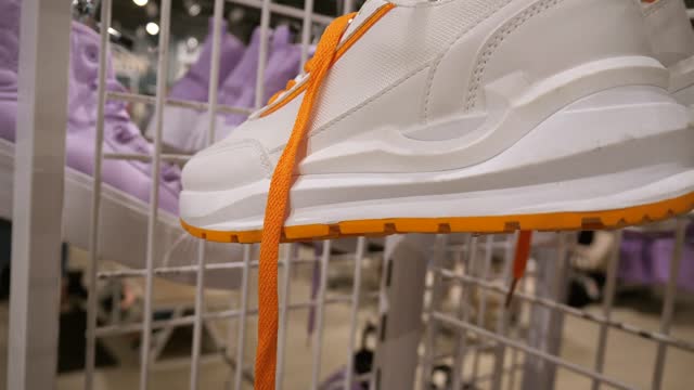 Sports white sneakers in the store.