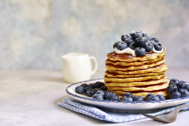 istock Stack of fresh hot pancakes with maple syrup and blueberries. 2091768567