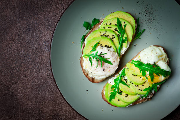 istock sandwich with cream cheese, sliced avocado and boiled egg, arugula, on grainy bread, homemade, breakfast, no people, 2091774234