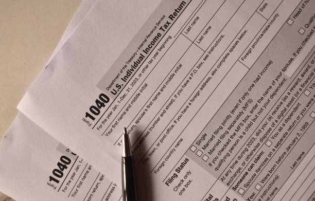 istock A closeup picture of a 1040 forms on a table with a black pen on it. 2091774751