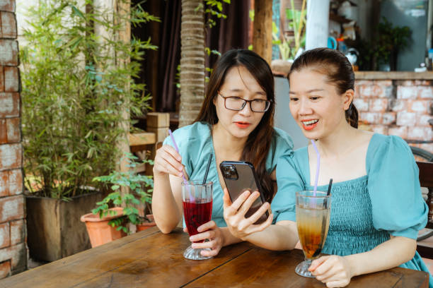 istock Two Women Enjoying Drinks at a Hanoi Cafe 2091777353