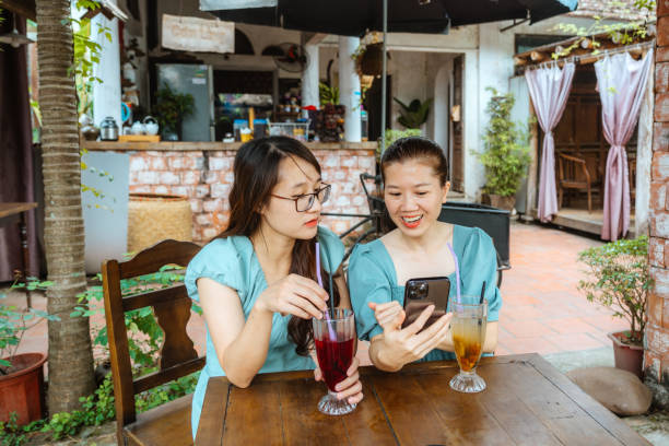 istock Friends Sharing Laughs at Outdoor Cafe in Hanoi 2091782607