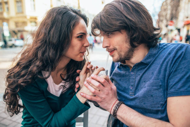 istock Couple in love drinking from one cup 2091782623
