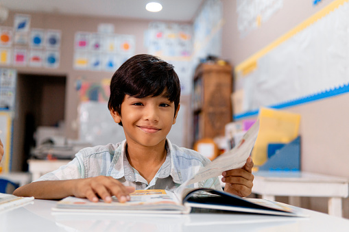 Portrait of latin american elementary child in a classroom.