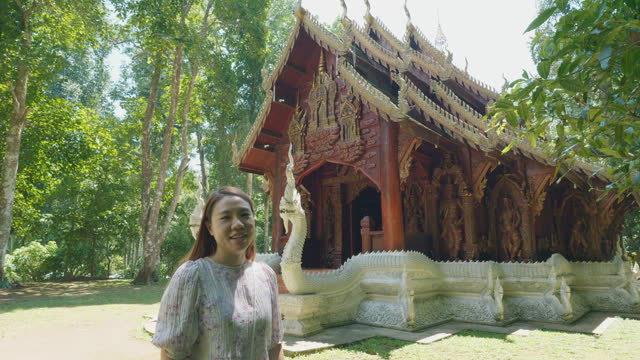 Woman tourist walk along entrance Wat Luang  Khun Win Chiangmai