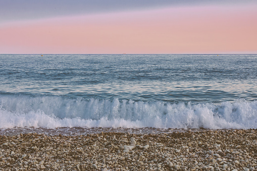 The Mediterranean sea and pebbles stones on a beach in Nice, France