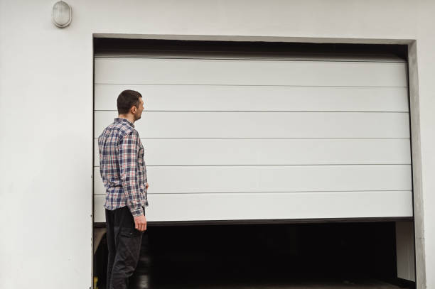 man closing garage door portrait.