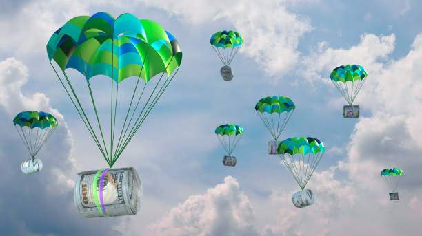 istock dollars attached to a parachute against the sky 2091841855