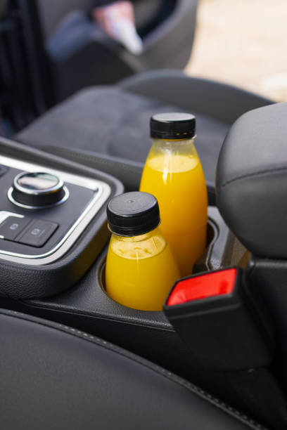 plastic bottle with fresh orange juice in a passenger car