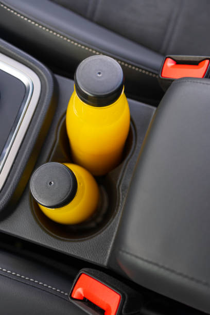 istock bottles with orange juice in a car 2091857374