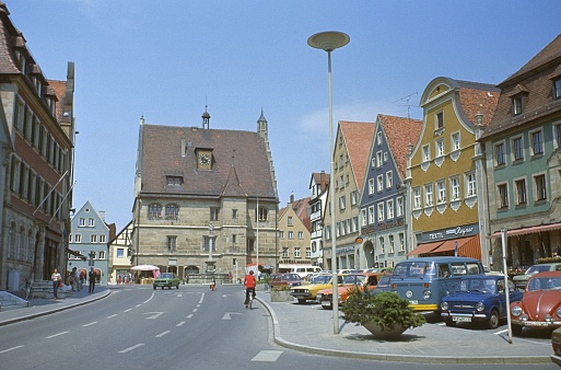 Weißenburg-Gunzenhausen, Middle Franconia, Bavaria, Germany, 1976. Street scene at the old market square in Weißenburg. In the background the old town hall. Furthermore: locals, buildings and parked cars.