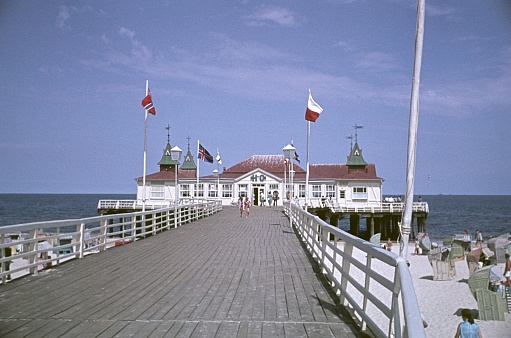 Ahlbeck, Mecklenburg Western Pomerania, GDR, Germany, 1969. The pier in Ahlbeck. Also: buildings, vacationers and beach chairs.