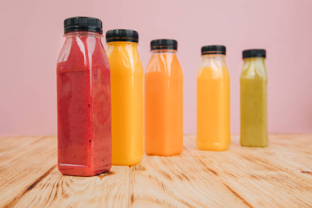 istock Fruit and vegetable smoothies in transparent plastic bottles. Red, green, orange smoothies on a wooden table. The concept of healthy eating 2091889312